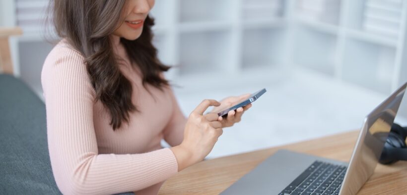 podnikání. Home lifestyle woman relaxing sleeping on sofa patio living room. Happy lady sitting on comfortable sofa using smartphone mobile while select listen music Tropical vacation